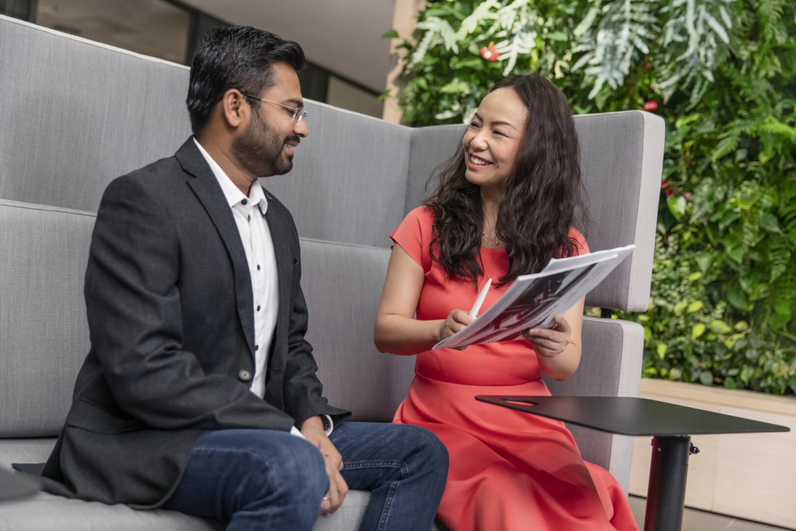 two people discussing documents with smiles on thier faces